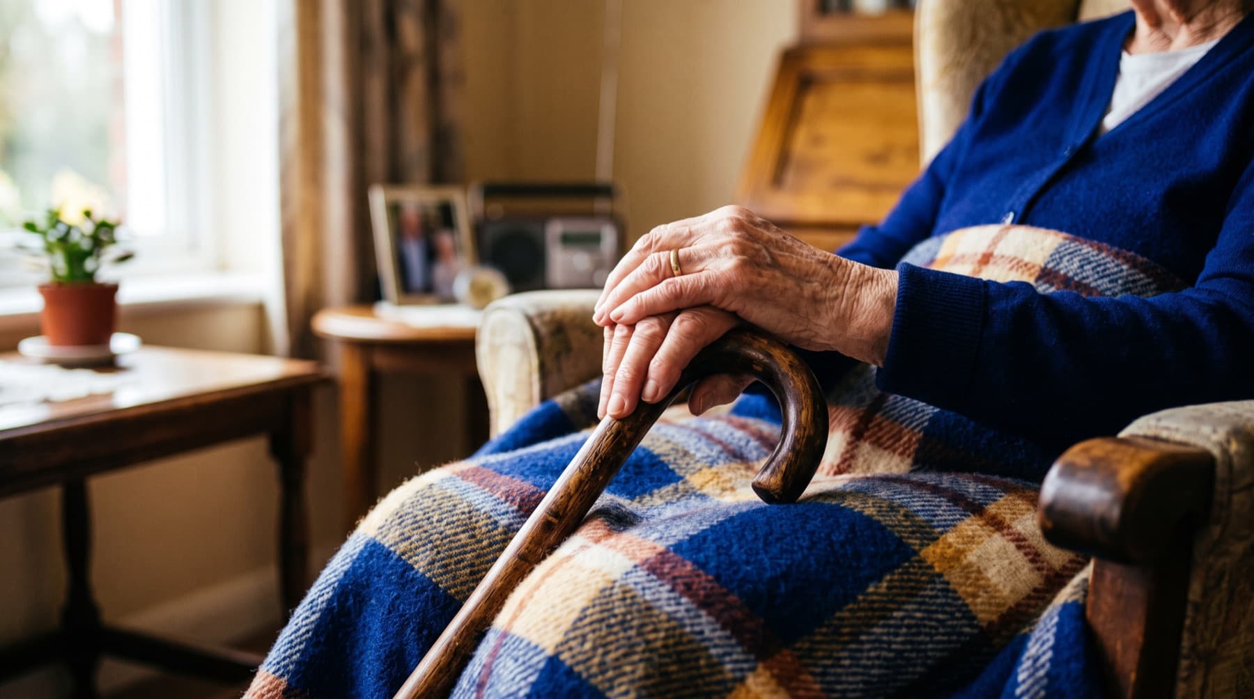 Houston Nursing Home Abuse Lawyer — an elderly resident's hands resting on a wooden cane in a softly lit care facility room